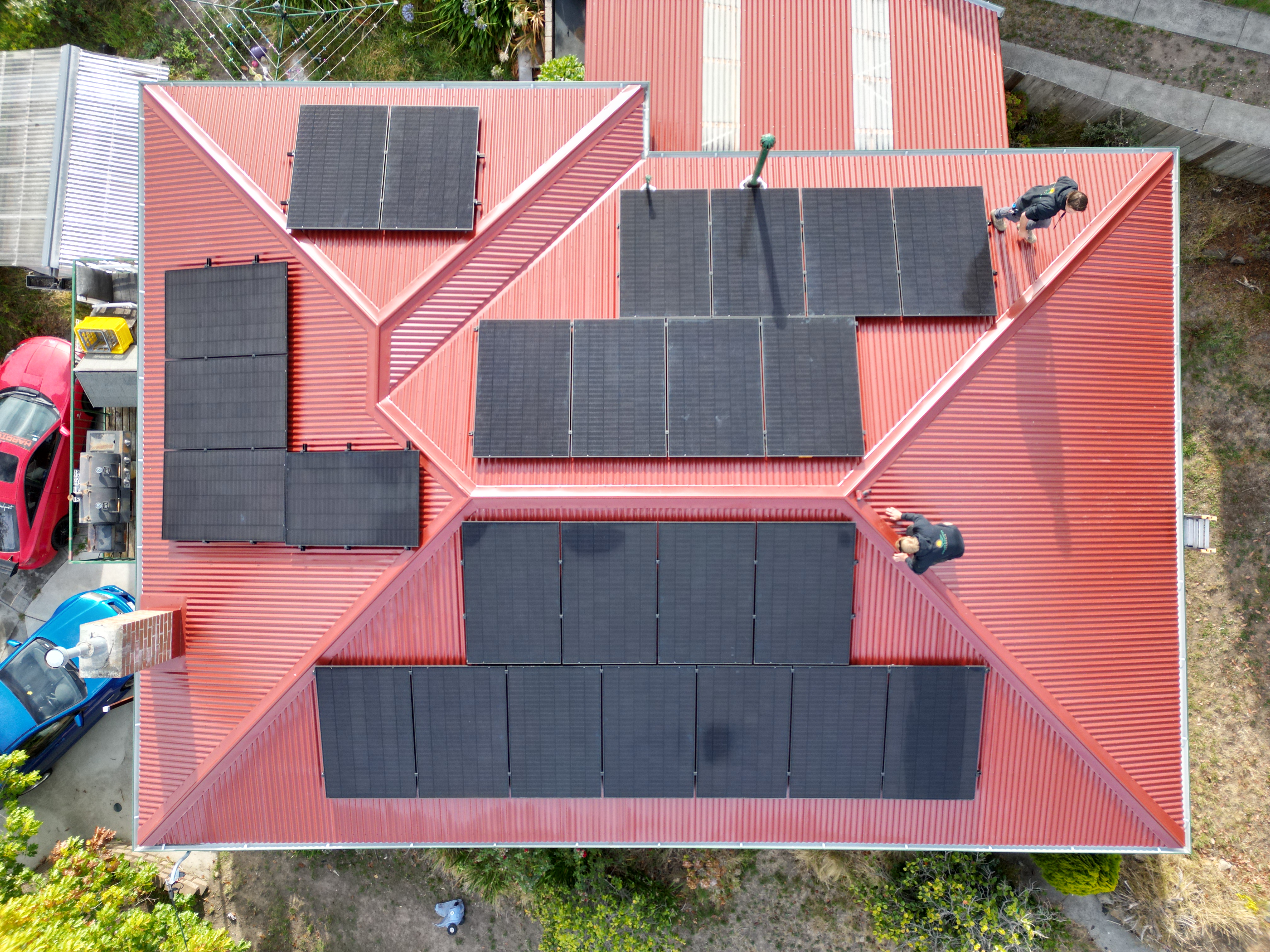 Aerial drone view of the Solar Coaster team installing panels on a terracotta roof
