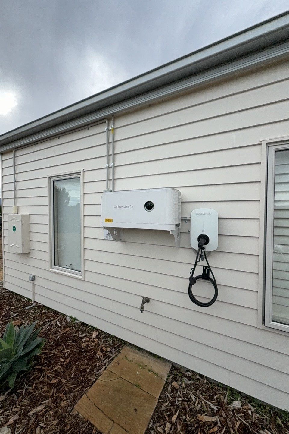 Solar inverter installed on a garage wall